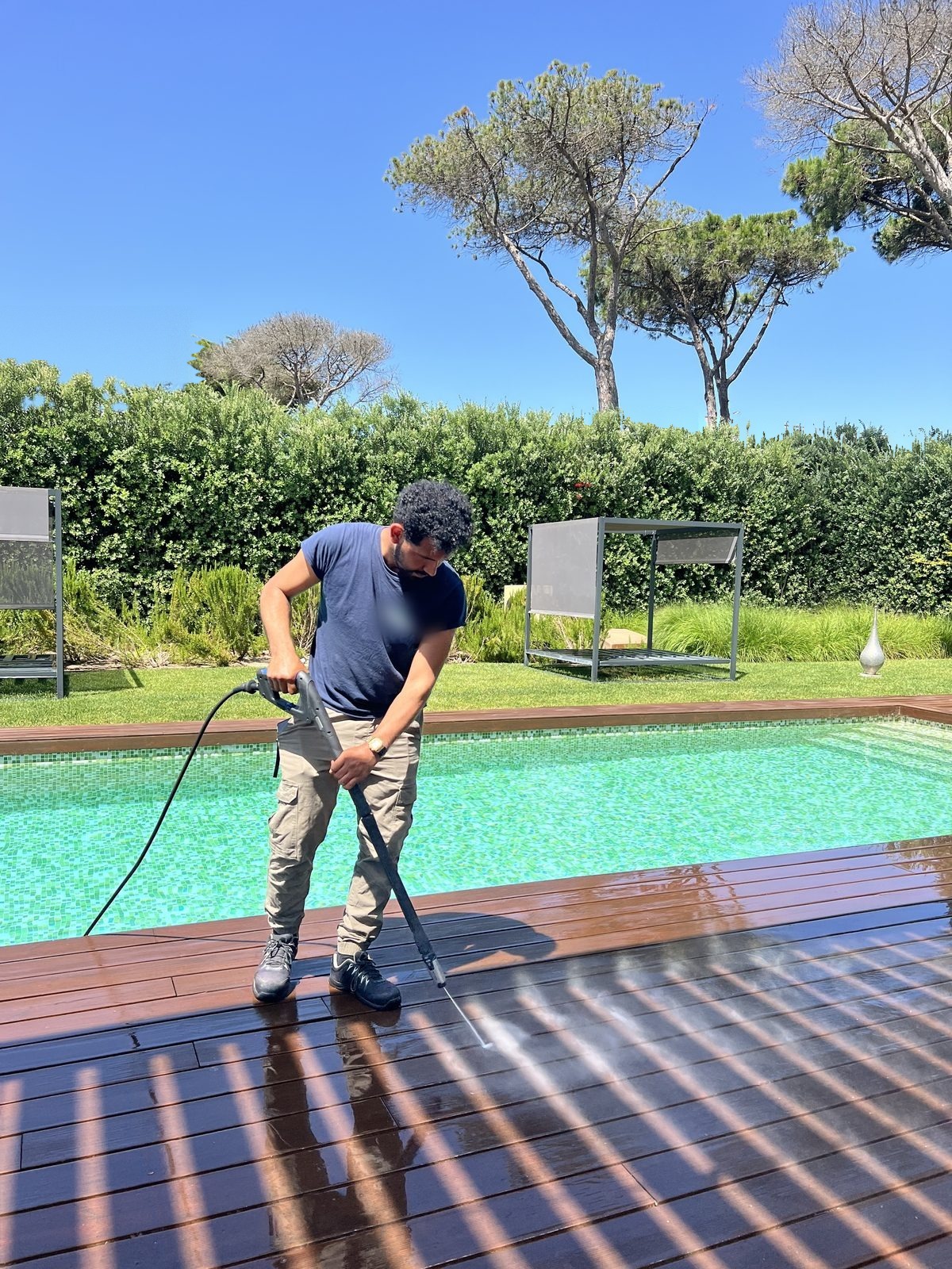 The pool deck being cleaned before the owners arrive